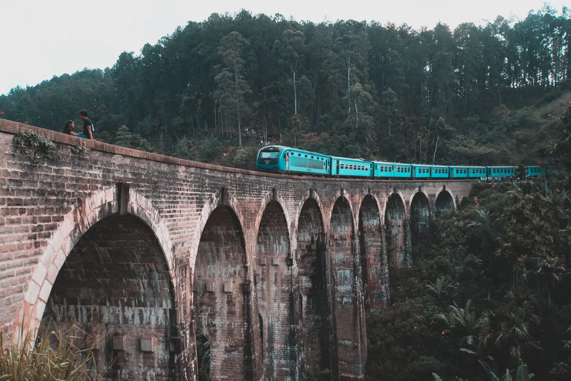 The Nine Arch Bridge surrounded by lush green hills in Ella, Sri Lanka